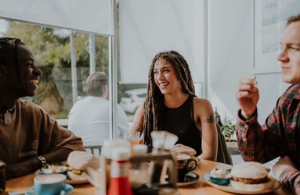 three people having lunch and laughing